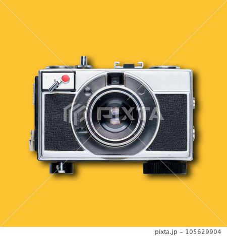 vintage old film camera on yellow background 105629904