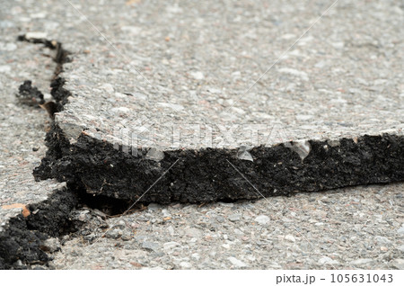 Selective focus on broken pavement road.Broken pavement road background and texture. 105631043