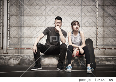 young asian adult man and woman resting relaxing outdoors after exercise 105631169