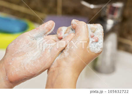 Kid is washing his hands in bathroom. Kid is washing his hands in bathroom. 105632722