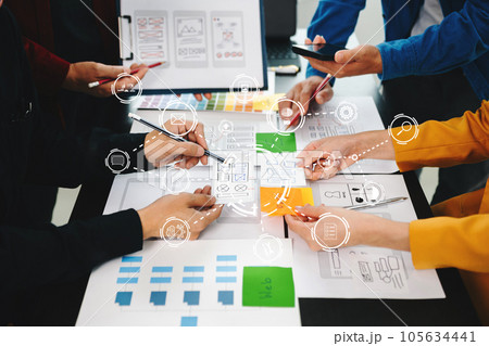Close up view of UI developer team brainstorming on their project with laptop, smartphone and digital tablet. Creative digital development agency.. Close up view of UI developer team brainstorming on their project with laptop, smartphone and digital tablet. Creative digital development agency.. 105634441
