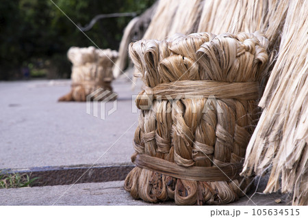 A thick brown  bundle of raw jute has on the ground 105634515