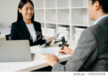 business people and lawyers discussing contract papers sitting at the table. Concepts of law, advice, legal services. in morning light business people and lawyers discussing contract papers sitting at the table. Concepts of law, advice, legal services. in morning light 105635203