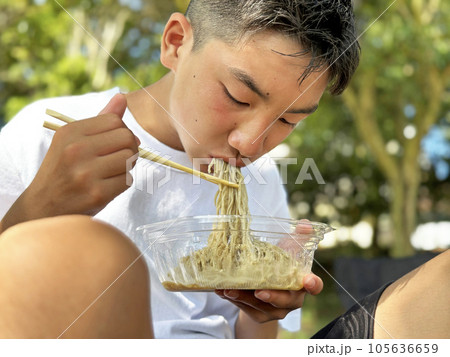コンビニで買った麺類を食べる少年 コンビニで買った麺類を食べる少年 105636659
