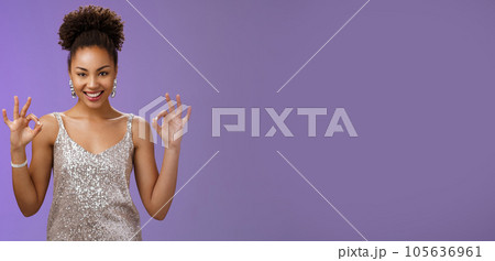 Got it perfect deal. Sassy confident attractive creative african-american female in silver glittering evening dress show okay ok gesture smiling devious have excellent idea plan, blue background 105636961