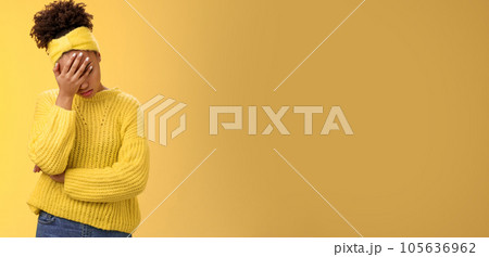 Upset tired african-american female entrepreneur facepalm bow head close eyes palm pressed face embarrassed stupid inappropriate behaviour drunk coworker standing annoyed irritated yellow background 105636962