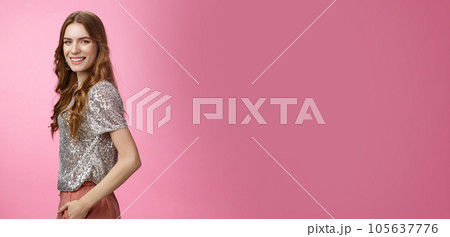 Profile confident stylish glamour young woman curly hairstyle glittering blouse turning camera smiling broadly white teeth, happy amused partying celebrating birthday joyfully, pink background 105637776