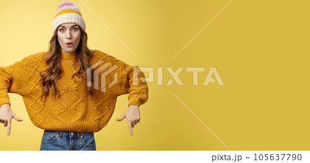 Wow stunning promo. Amused surprised good-looking stylish glamour young woman promoting interesting copy space folding lips amazed widen eyes pointing index fingers down bottom advertisement 105637790