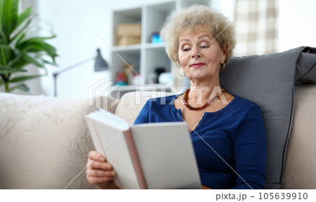 Portrait of adult woman reading interesting book Portrait of adult woman reading interesting book 105639910