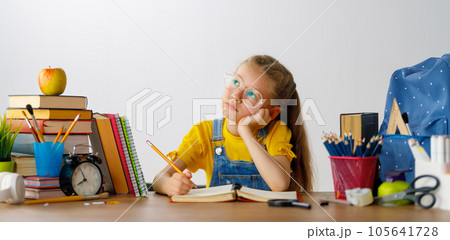 Thinking child is sitting at desk Thinking child is sitting at desk 105641728
