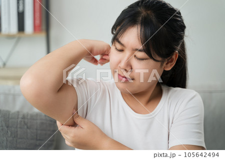 Close up of Chubby woman pinching upper arm fat. weight loss concept. Close up of Chubby woman pinching upper arm fat. weight loss concept. 105642494