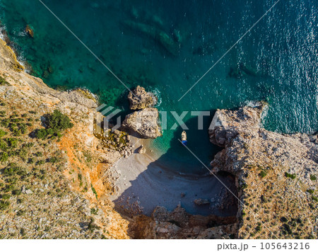 Top view of a beautiful sea harbor. Lagoon with dark blue water. Waves near rocky coast 105643216