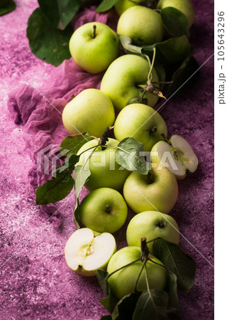 Fresh ripe green apple in purple background. 105643296
