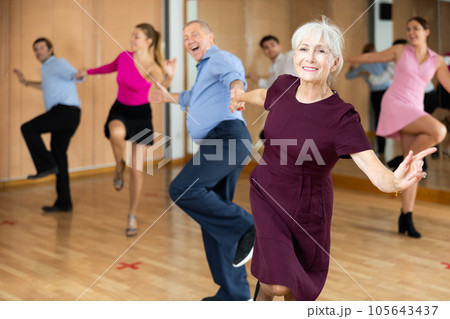 Older woman enjoying active dancing in dance studio 105643437
