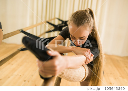 Ballerina in pointe pose. Beautiful ballet dancer stretching in class. Ballerina woman training Ballerina in pointe pose. Beautiful ballet dancer stretching in class. Ballerina woman training 105643840