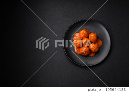 Delicious fresh meatballs in tomato sauce with salt, spices and herbs 105644128
