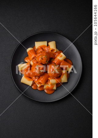 Delicious fresh meatballs and pasta in tomato sauce with salt, spices and herbs 105644166