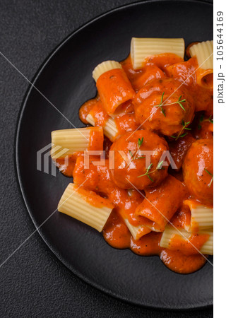 Delicious fresh meatballs and pasta in tomato sauce with salt, spices and herbs 105644169