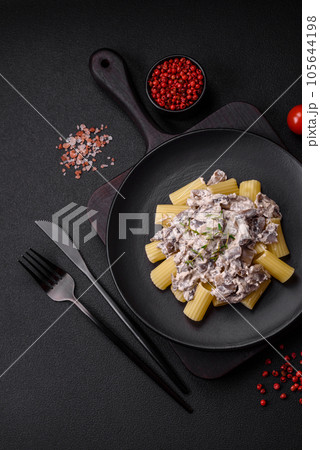 Delicious fresh pasta with champignon mushrooms in a creamy sauce Delicious fresh pasta with champignon mushrooms in a creamy sauce 105644198
