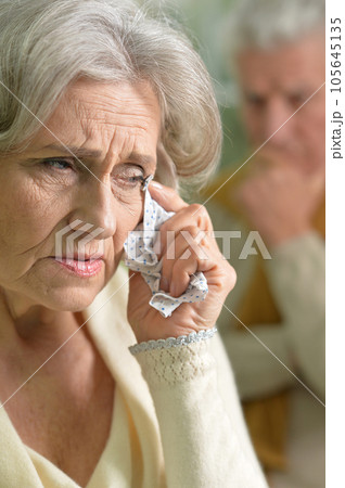 Close-up portrait of a sad elder couple  105645135