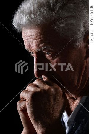 Close-up portrait of a senior man thinking about something 105645136