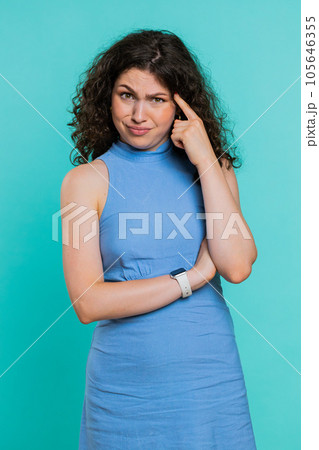 Displeased woman pointing at camera show stupid idiot gesture finger near head dumb insane plan idea Displeased woman pointing at camera show stupid idiot gesture finger near head dumb insane plan idea 105646355