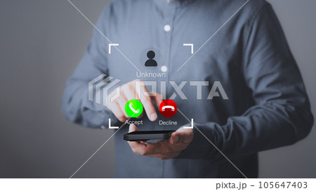 Man answering the incoming call. The phone call was from an unknown number. Call center gang or stranger. Hoax person with a fake identity. Concept of scam, fraud with a smartphone from the criminal. Man answering the incoming call. The phone call was from an unknown number. Call center gang or stranger. Hoax person with a fake identity. Concept of scam, fraud with a smartphone from the criminal. 105647403