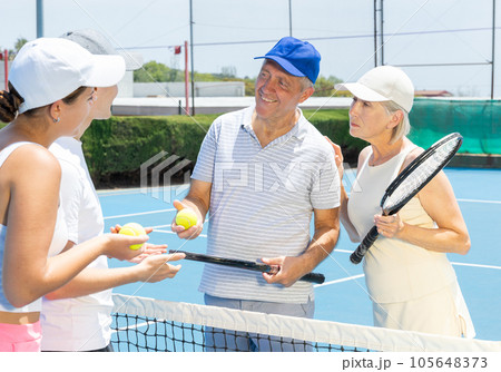 Portrait of smiling tennis team. Portrait of smiling tennis team. 105648373