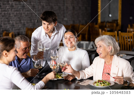 Large family, company of spouses in restaurant, eat, celebrate important event, communicate. Large family, company of spouses in restaurant, eat, celebrate important event, communicate. 105648383