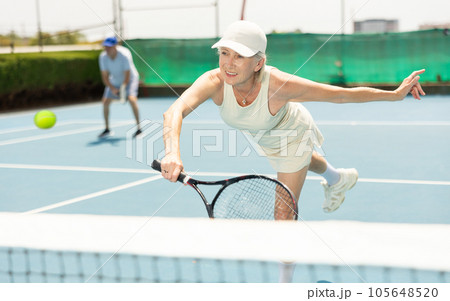 Senior woman plays tennis 105648520