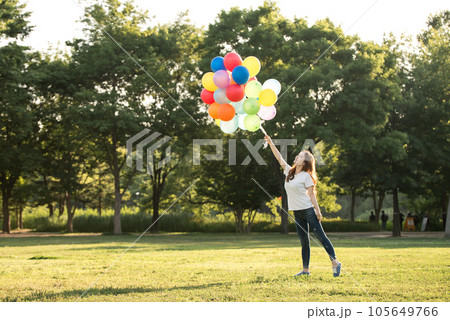 smiling woman with colorful balloons outdoors 105649766