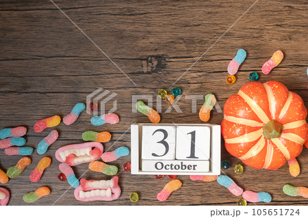 Happy Halloween day with ghost candies, pumpkin,  bowl and 31 October calendar. Trick or Threat, Hello October, fall autumn, Festive, party and holiday concept 105651724