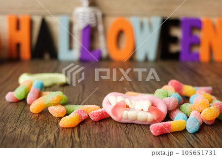 Happy Halloween day with ghost candies, pumpkin bowl, Jack O lantern and decorative (selective focus). Trick or Threat, Hello October, fall autumn, Festive, party and holiday concept 105651731