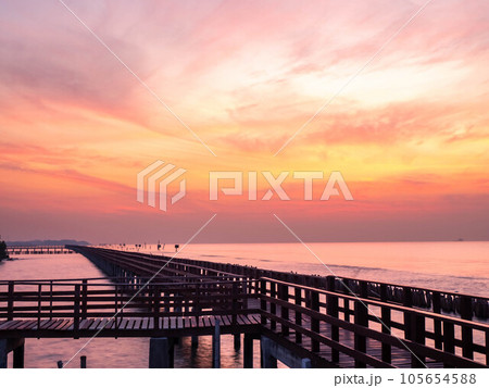 Sea view near mangrove forest with man made wooden barrier for wave protection, under morning twilight colorful sky Sea view near mangrove forest with man made wooden barrier for wave protection, under morning twilight colorful sky 105654588