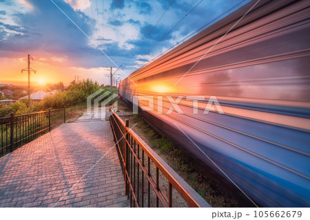 High speed train in motion on the railway station at sunset High speed train in motion on the railway station at sunset 105662679