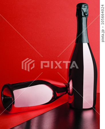 two red bottles of champagne on red background 105664024