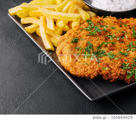 Fried wiener schnitzel from veal topside with french fries 105664029