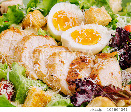 Caesar salad with chicken breast closeup Caesar salad with chicken breast closeup 105664041