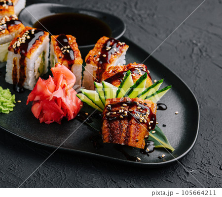 Canadian roll with eel on black plate from stone Canadian roll with eel on black plate from stone 105664211