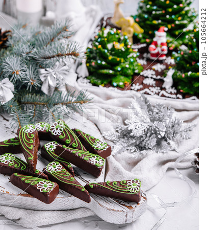 Chocolate brownies in shape of christmas trees with green icing Chocolate brownies in shape of christmas trees with green icing 105664212
