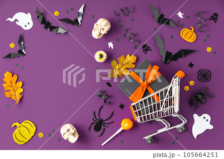 Spooky Halloween composition made of shopping basket and halloween decorations, 105664251