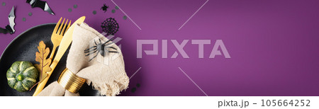 Halloween table setting with cutlery and decorations on purple background banner 105664252