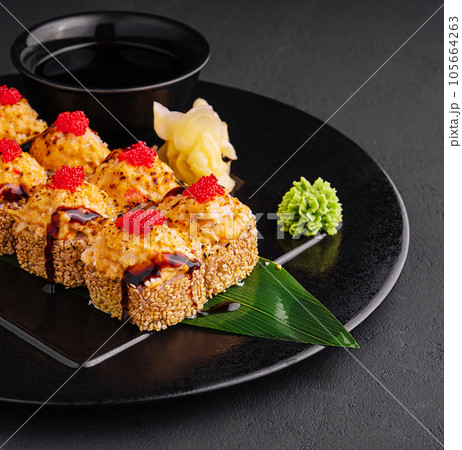 Traditional baked japanese sushi on black plate 105664263
