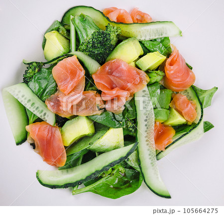 Salmon avocado salad with salted fish, lettuce, broccoli and cucumbers Salmon avocado salad with salted fish, lettuce, broccoli and cucumbers 105664275