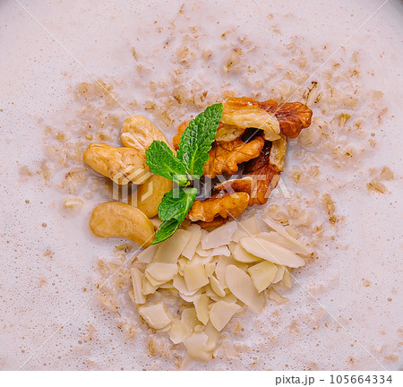 Homemade oatmeal flakes porridge with nuts Homemade oatmeal flakes porridge with nuts 105664334