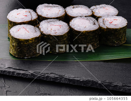 Crab stick maki sushi on black tray Crab stick maki sushi on black tray 105664355