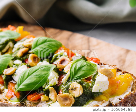 bruschetta with pesto, hazelnuts, cheese and basil bruschetta with pesto, hazelnuts, cheese and basil 105664369