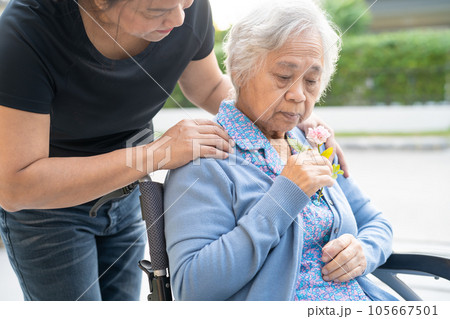 Caregiver help and care Asian senior woman patient sitting on wheelchair to ramp in nursing hospital, healthy strong medical concept. Caregiver help and care Asian senior woman patient sitting on wheelchair to ramp in nursing hospital, healthy strong medical concept. 105667501