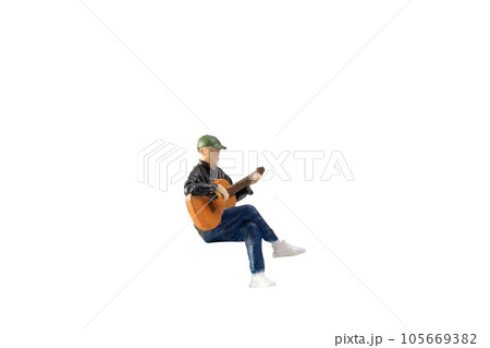 Miniature Musician with guitar isolated on white background with clipping path 105669382
