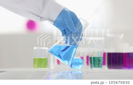 A male chemist holds test tube of glass A male chemist holds test tube of glass 105670830